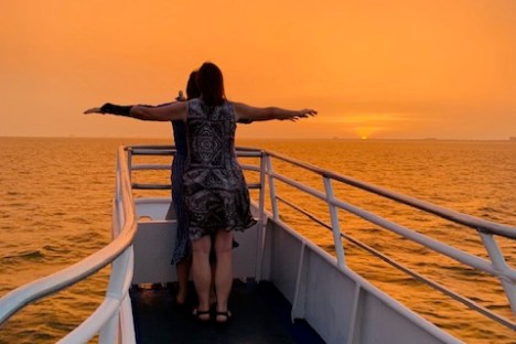 a person standing next to a body of water