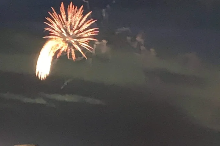 fireworks in the sky over a body of water